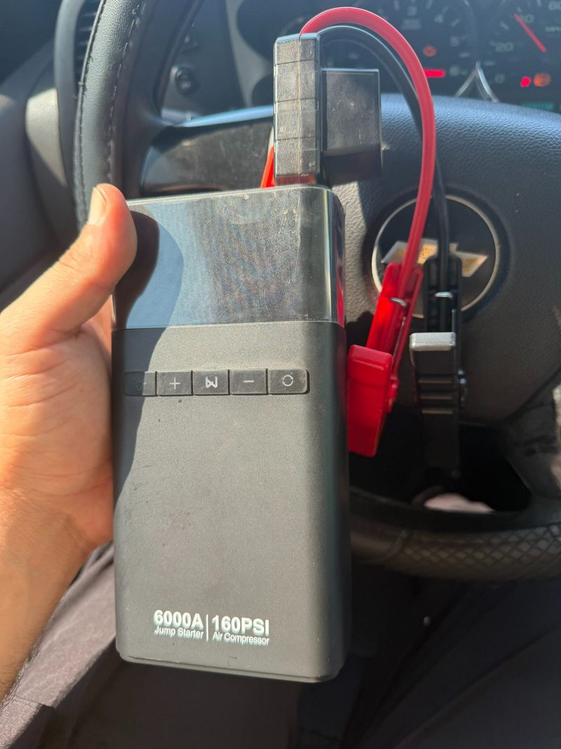 Image of a portable jump starter with air compressor capabilities for roadside assistance
