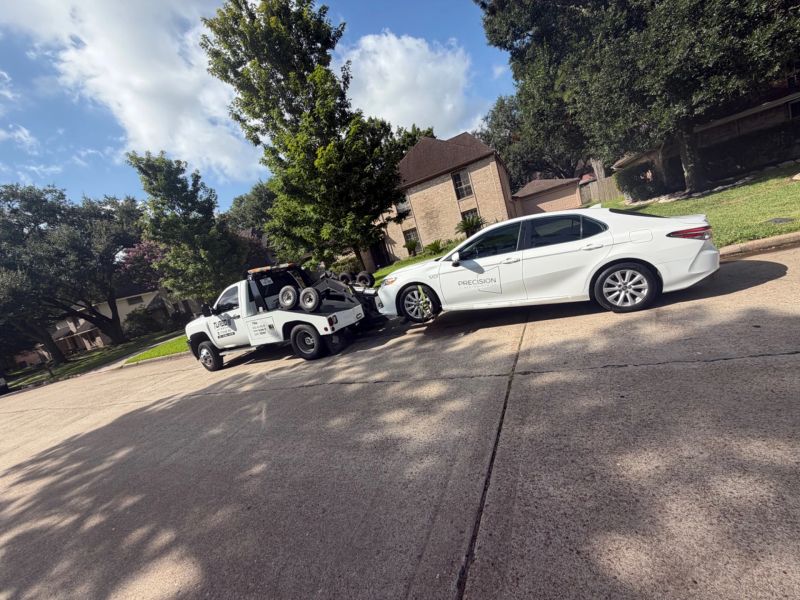 Turbo Tows truck towing a car in residential Houston area