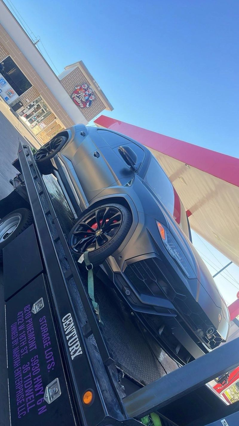 A Lamborghini Urus being towed by Turbo Tows service on a flatbed turck in Houston, showcasing their emergency towing capabilities.